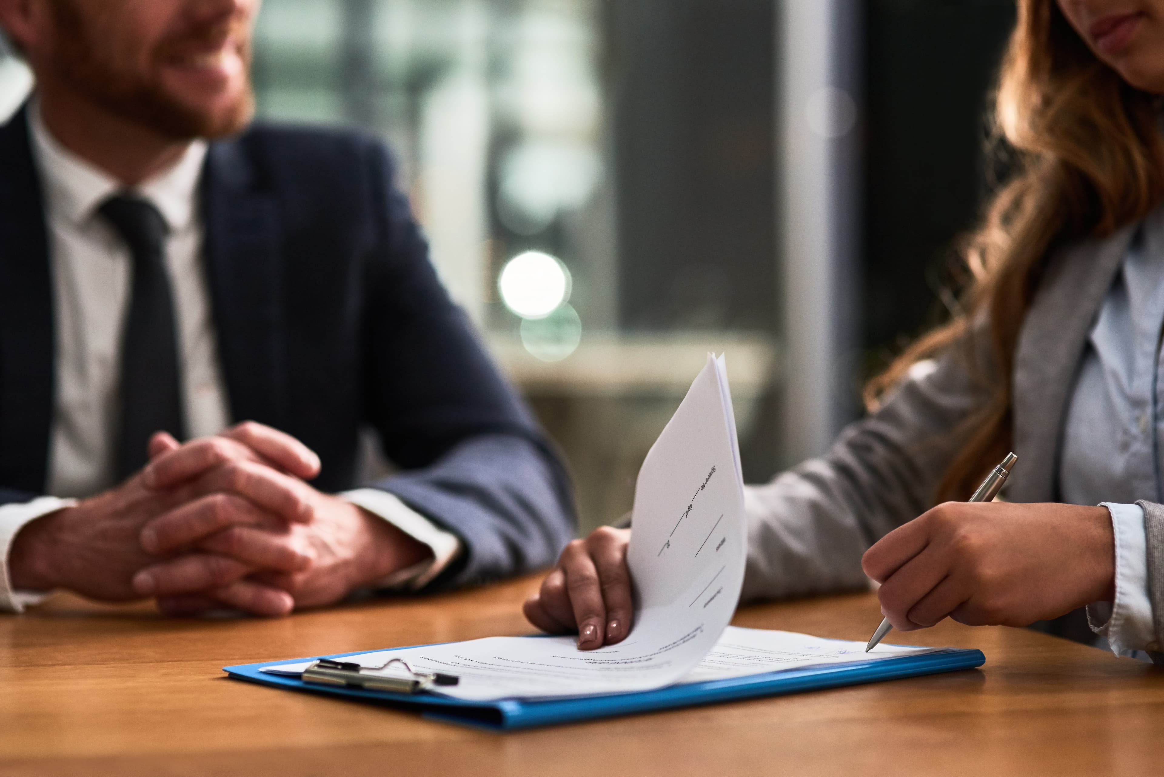 Business people signing contract documents